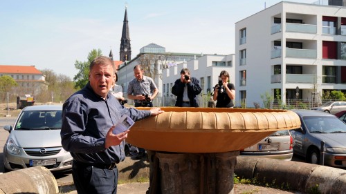 Uwe Ostmann erläutert der versammelten Presse, die Reparatur des Brunnens - Anklicken zum Vergrößern