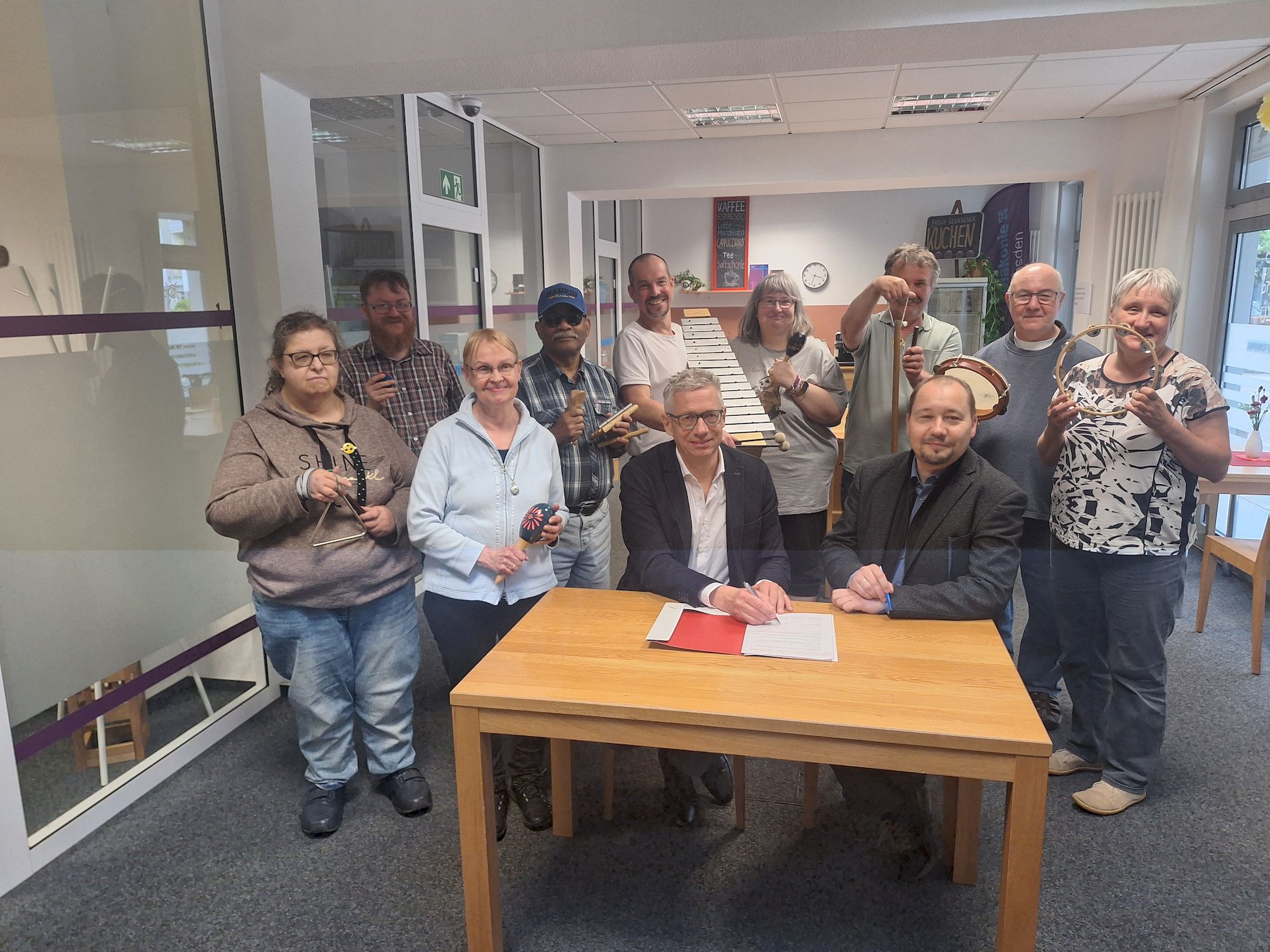 Jörg Polenz und Thomas Slesazeck unterzeichnen vor dem Ensemble der Köigskinder die "strategische Partnerschaft".